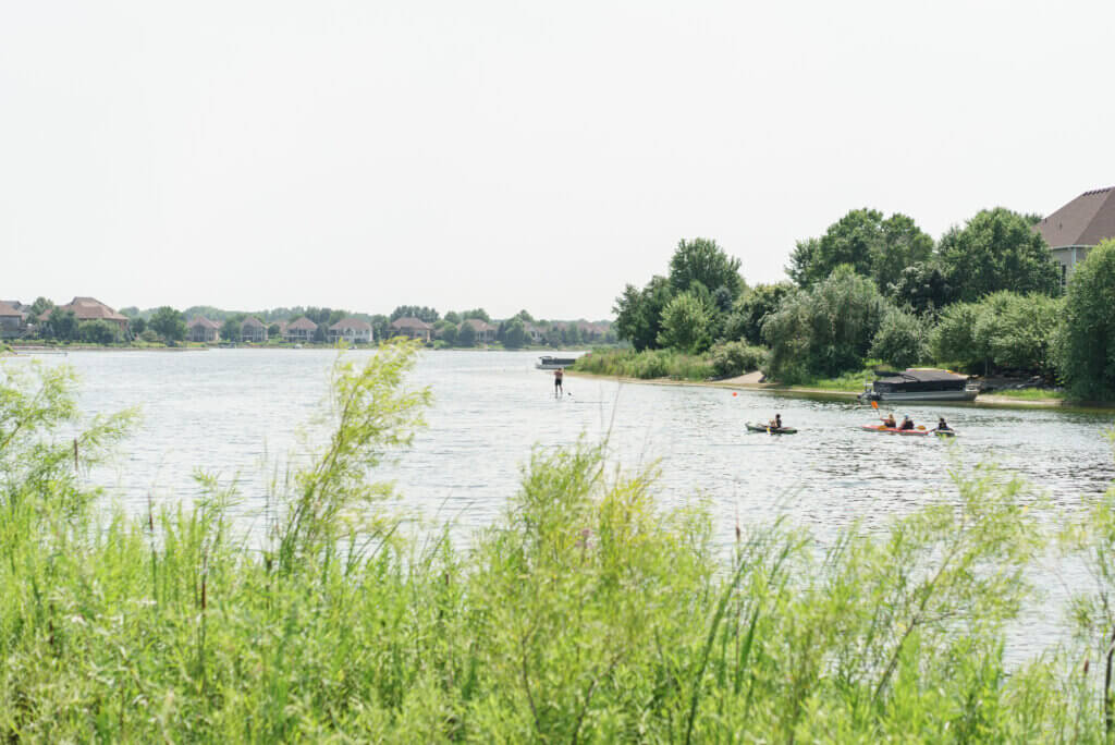 Lake with foliage in foreground. 