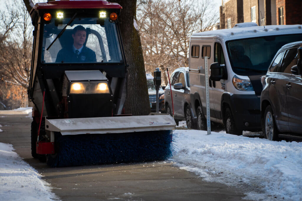 Rotary brush clears snow. 