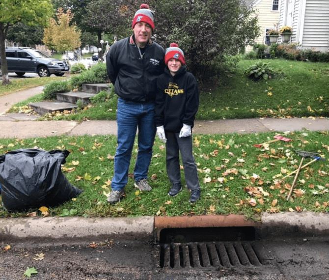 Drain adopters smiling near their cleaned storm drain. 